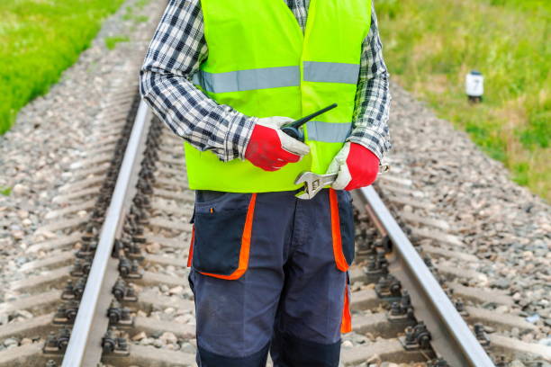 istock Worker with walkie talkie and adjustable wrench on railway track 1030298736
