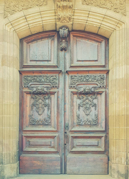 istock Old wooden gate with carved patterns. Toned picture 1030303530