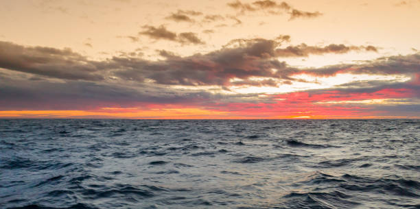 istock Seascape. Colorful sunset in the cloudy sky 1030304074