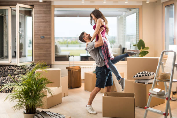 istock Young playful couple having fun while moving into new penthouse. 1030310704