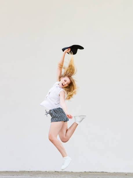 istock Woman in summer clothes jumping with sun hat 1030311108