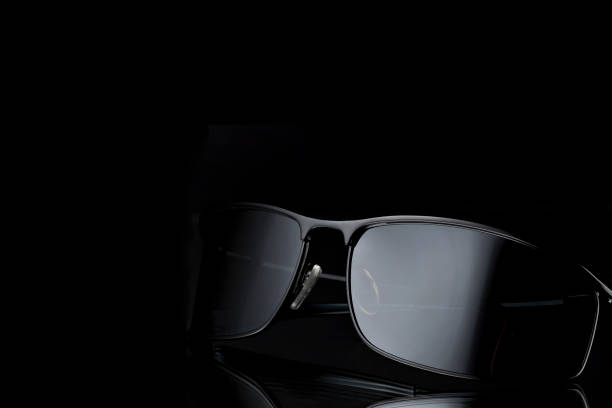 istock Trendy black sunglasses on black background. 1030314346