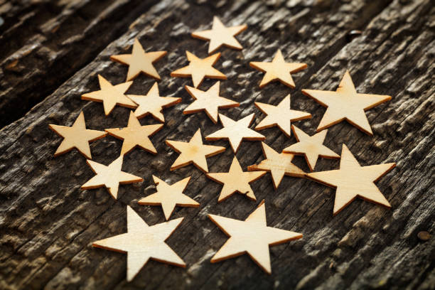 istock Wooden carved stars on tree bark 1030314654