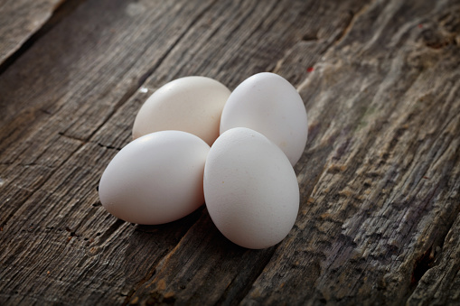 White chicken eggs, on wooden surface