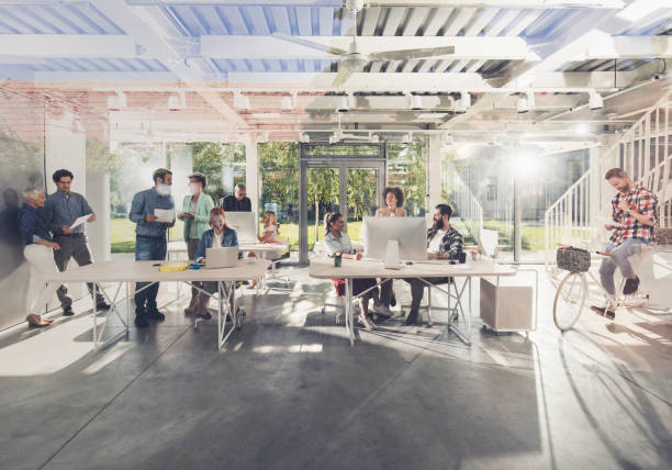 istock Large group of happy freelance workers working in a modern office. 1030315702