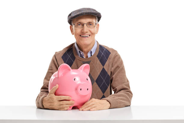 istock Senior man with a piggy bank 1030318720