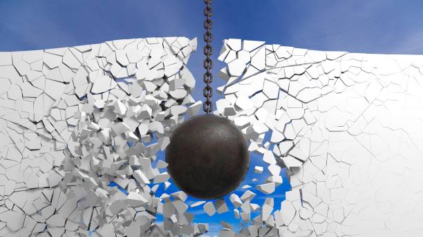 istock Metallic rusty wrecking ball breaking the wall, with blue sky. 3D rendering 1030319718