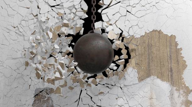 istock Metallic rusty wrecking ball on chain shattering  an old wall. 3D rendering 1030319736