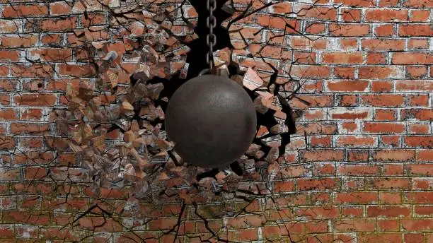 Photo of Metallic rusty wrecking ball on chain shattering an old brick wall. 3D rendering