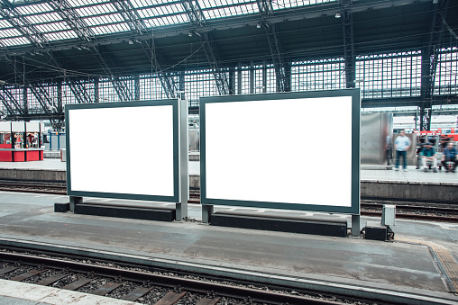 Two blank billboards at railroad station