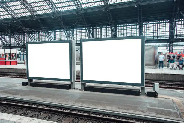 Two blank billboards at railroad station