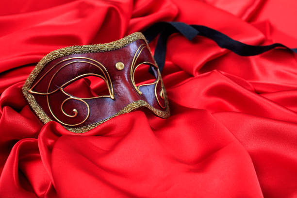 istock Carnival mask on red satin background 1030323168