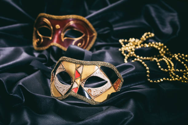 istock Carnival masks on black satin background 1030323224
