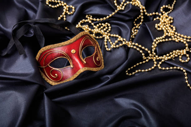 istock Carnival mask isolated on black satin background 1030323244