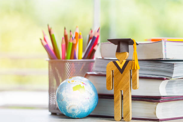 istock Australia Education knowledge learning study abroad international Ideas. Student Sign wood with Graduation celebrating cap open textbook with model global map, alternative studying world wide 1030329046