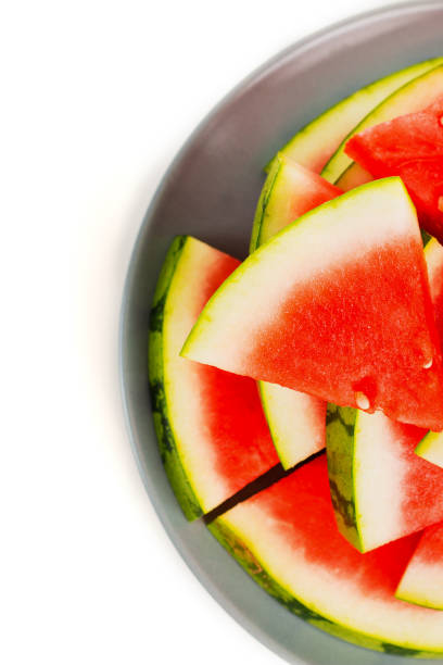 istock Sliced red watermelon on grey plate isolated. View from above. 1030329254