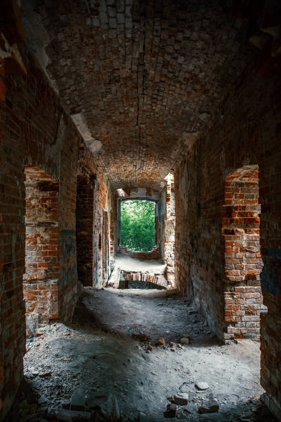 istock Corridor in ruined, abandoned ancient brick aged castle building 1030329710