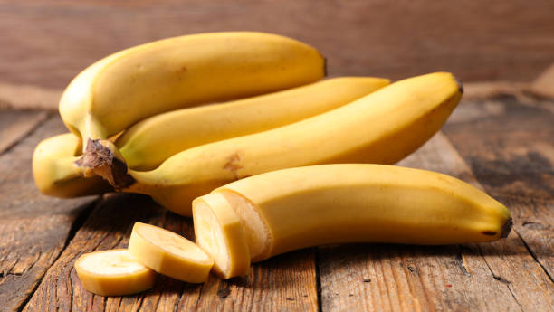 istock banana on wood background 1030334560