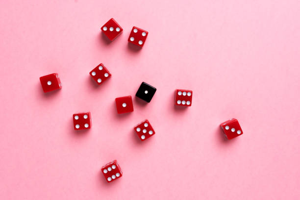 istock Red and black gaming dices on pink background 1030337222