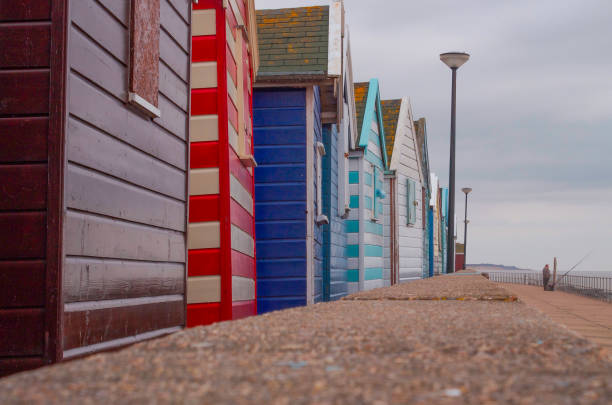 istock Beach Huts with Fisherman 1030344710
