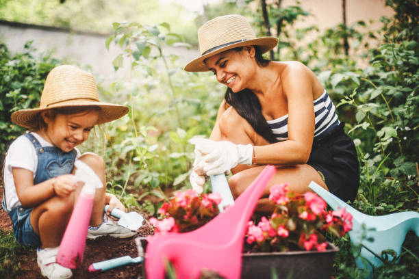 istock Single mother with her daughter gardening 1030345664