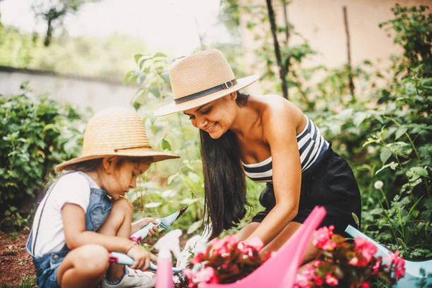 istock Single mother with her daughter gardening 1030345854