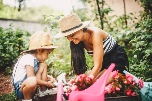 istock Single mother with her daughter gardening 1030348082