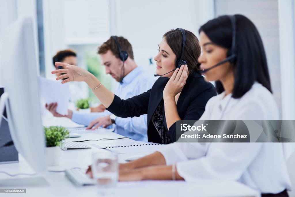 They do it all with one call Shot of a team of young people working in a call center Customer Service Representative Stock Photo