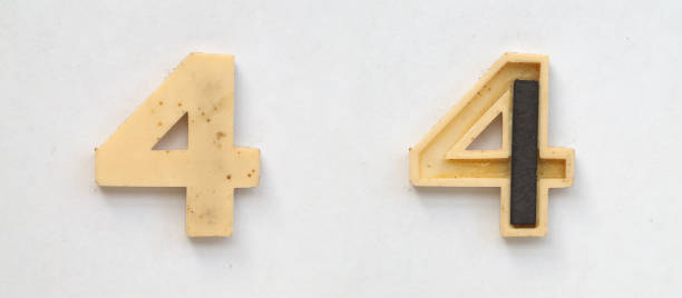istock bright plastic numbers with magnet on white paper 1030357378