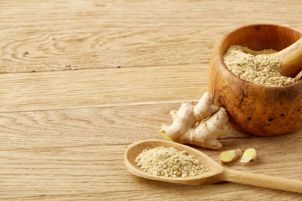 istock Wooden mortar and pestle with ginger and grind spicies on rustic table, close-up, selective focus 1030359228