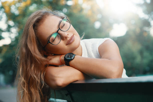 Positive woman having a break from city noise and work while bre
