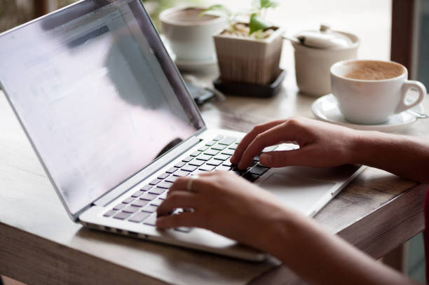 istock Young woman freelancer typing in laptop in cafe 1030362174