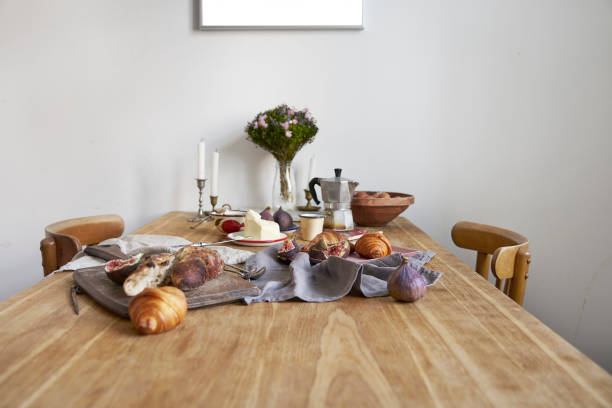 istock White kitchen interior with provence breakfast on wooden table, poster on the white wall, space for design layout 1030362872