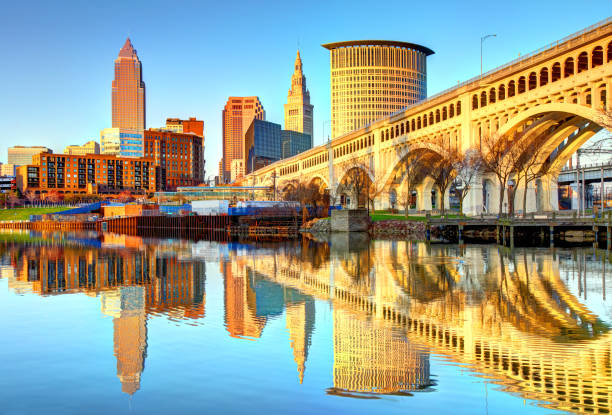 Cleveland Skyline reflecting on the Cuyahoga River Cleveland is a city in the U.S. state of Ohio and is the county seat of Cuyahoga County, the most populous county in the state cuyahoga river photos stock pictures, royalty-free photos & images