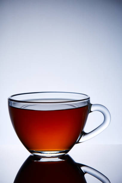 istock Glass transparent empty teacup on a light grey background, close-up, vertical. 1030367456