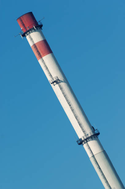 istock Tall chimney of heating plant on blue sky 1030370780