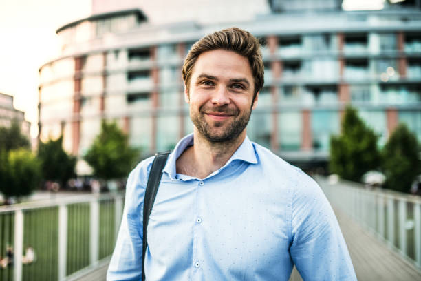 istock A young businessman with a bag walking on a bridge. 1030371526