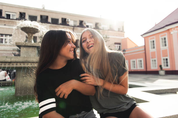 Two teenage girls having fun in the urban part of the city.