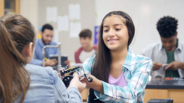 istock Cheerful students build robotic vehicle 1030375030