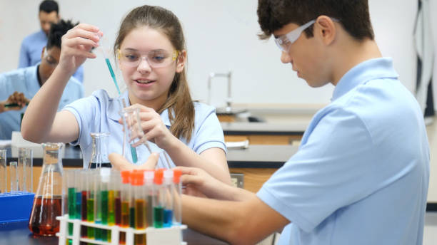 istock High school students participate in chemistry experiment 1030375096