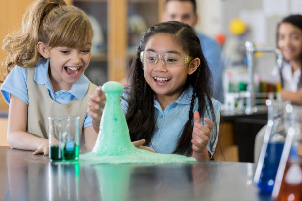 istock Schoolgirls participate in chemistry experiment 1030375444