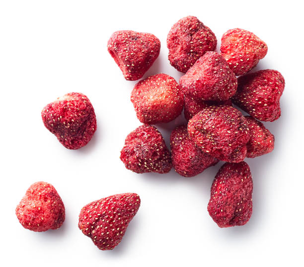 Heap of freeze dried strawberries isolated on white background. Top view