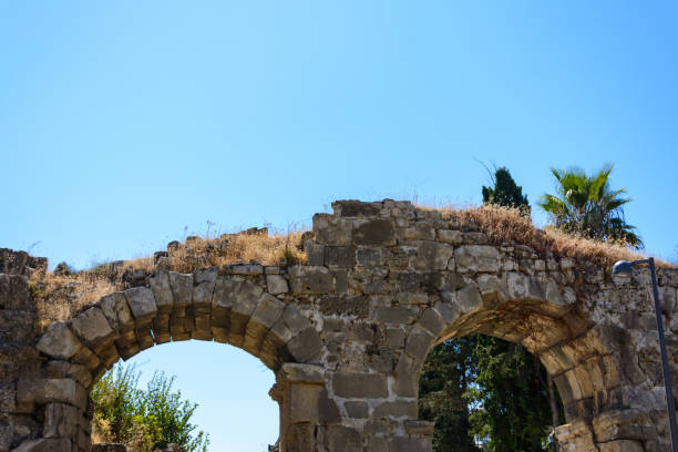 istock antique stone arched bridge with two spans. Side, Turkey 1030375818