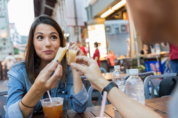 istock Young couple toast with egg rolls during Singapore vacation 1030375988