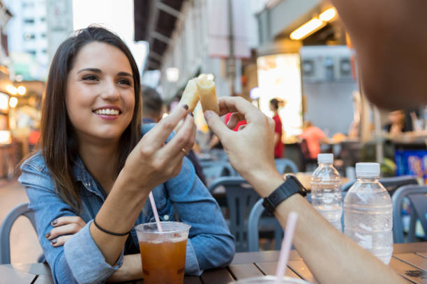 istock Young woman enjoys egg roll toast with boyfriend 1030376002