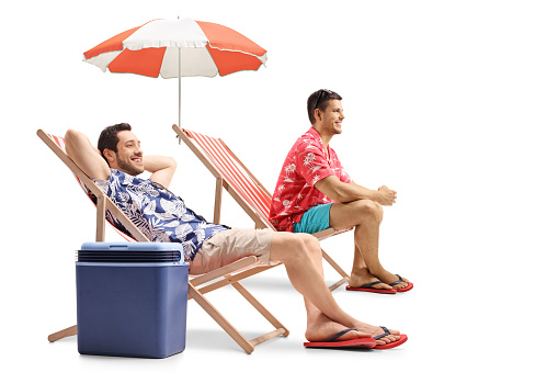 Tourists sitting in deck chairs isolated on white background