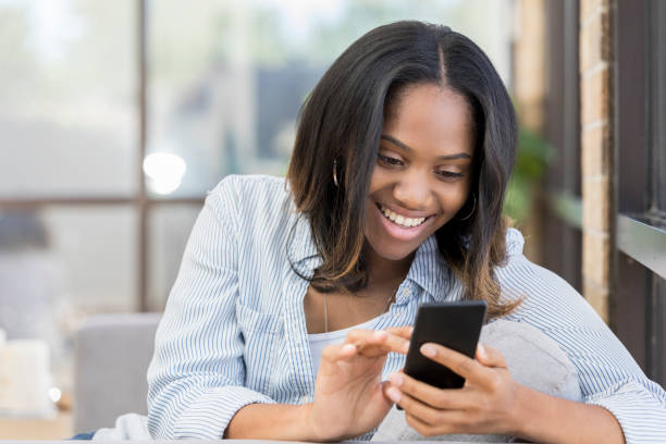 istock Cheerful woman uses smartphone 1030376368