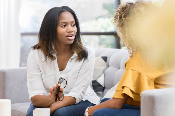 istock Vulnerable young woman discusses something with her friend 1030376434