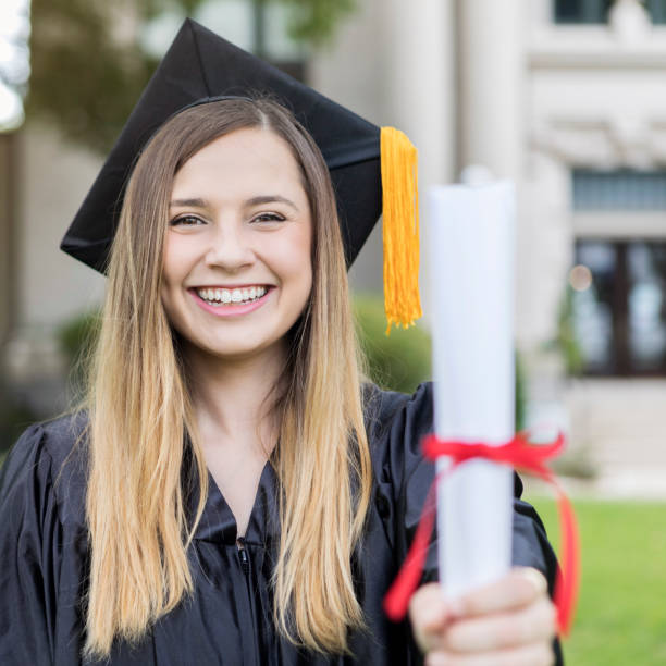 istock Young Hispanic woman shows off college diploma 1030376554