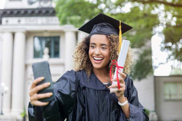 istock Excited college grad taking selfie 1030376602